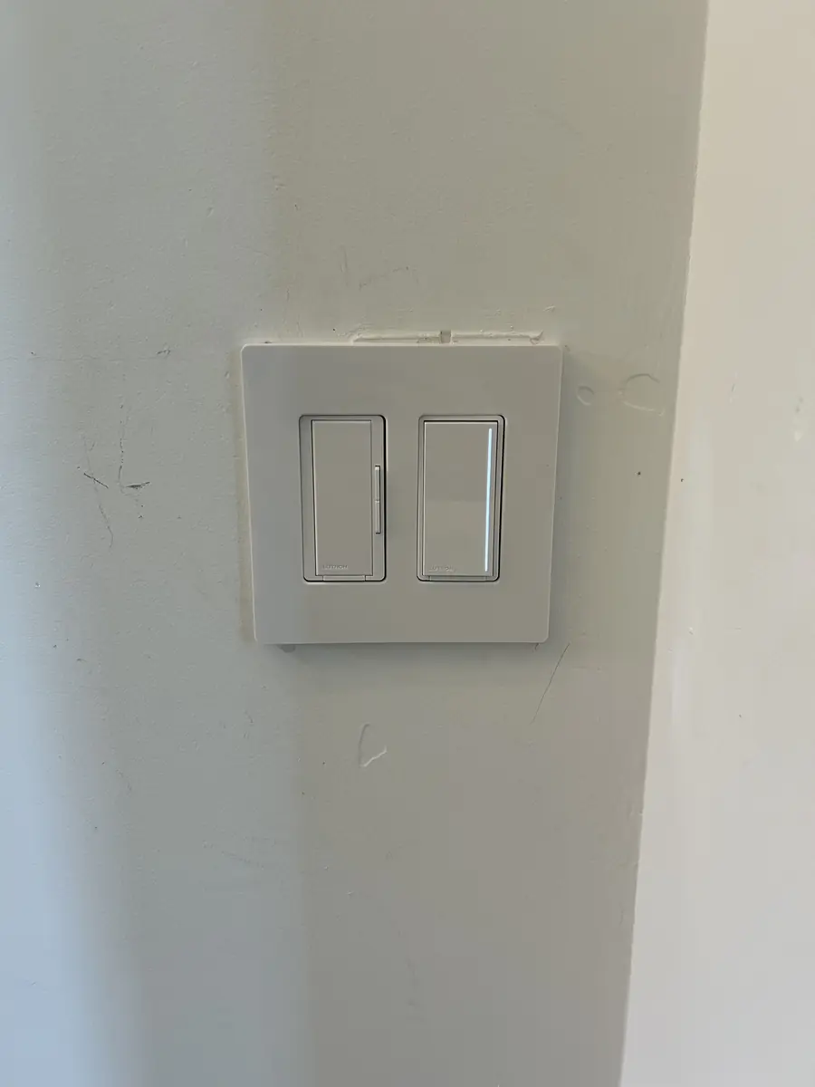 Two-gang Lutron dimmer and switch with a screwless white wall plate